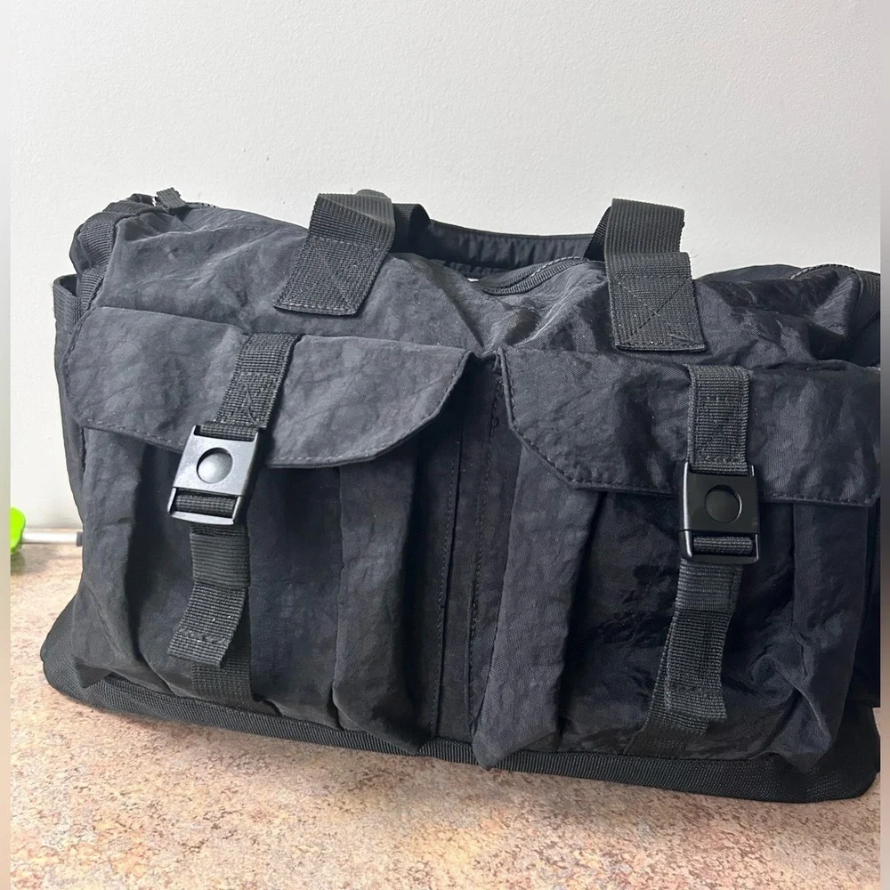 Tommy Bahama black travel duffle bag with hand and shoulder straps